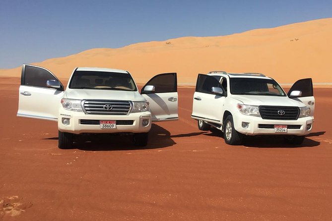 Abu Dhabi Desert Safari with BBQ Dinner & Shows - Sandboarding and the red-dune sunset