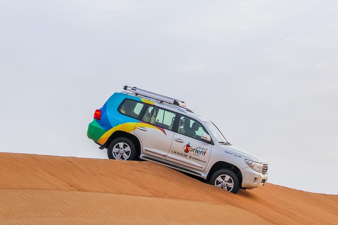 Classic Dubai Desert Safari with BBQ Dinner and Camp activities - Meeting camels before sunset