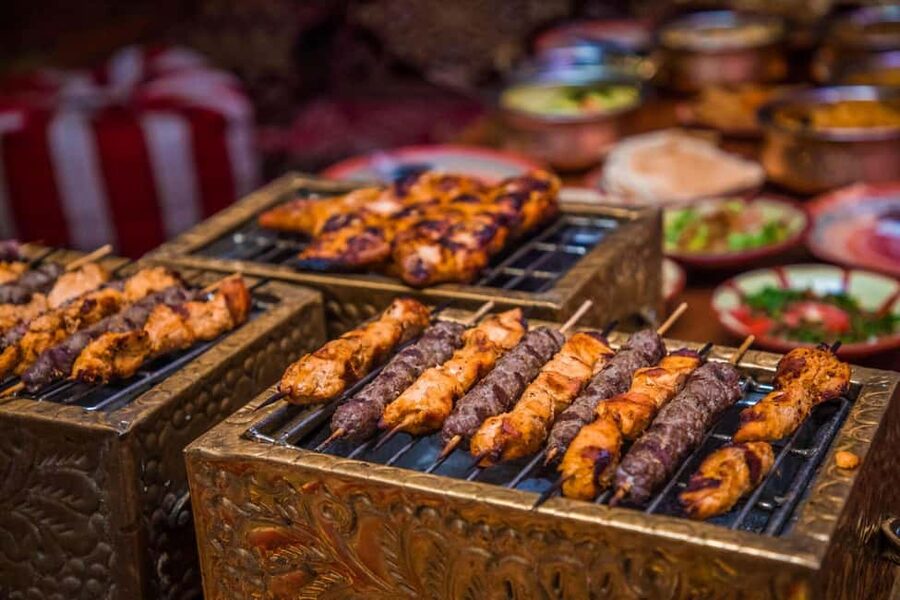Desert Safari Dubai with Camel Ride, Sandboarding & Dinner - Al Aweer camp: dinner and desert customs