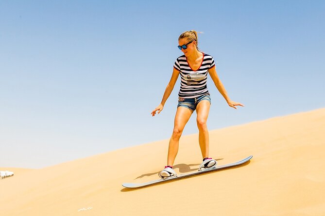 Desert Safari with BBQ Dinner, Camel Ride, Sand Board & Live Show - Red dunes and a full evening of desert activities