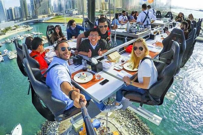 Dinner In The Sky at Dubai Marina with Optional Transfers - Sitting down at Dubai Marina before the lift