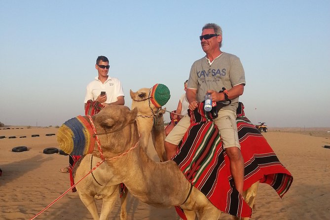 Dubai Desert Morning Tour in 4WD Vehicle: Camel Ride, Quad Bike Tour, Sandboarding, and Camel Farm - Quad biking across the open sand