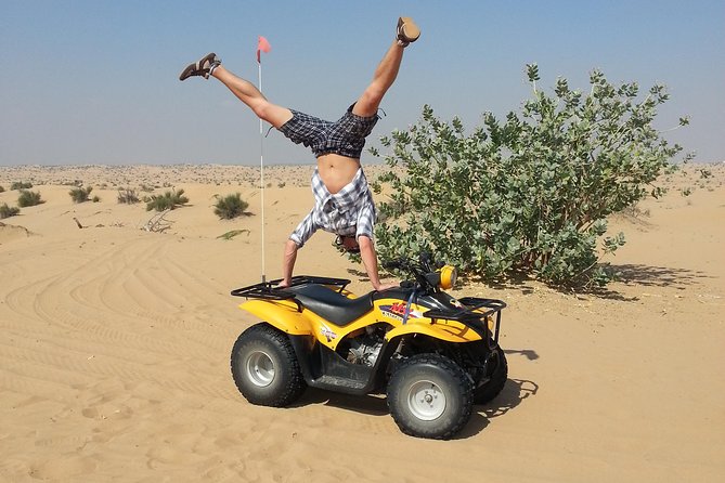 Dubai Desert Morning Tour in 4WD Vehicle: Camel Ride, Quad Bike Tour, Sandboarding, and Camel Farm - Sandboarding down the dunes