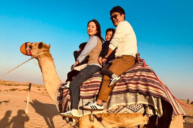 Dubai Desert Safari:BBQ Dinner, Dune Bashing & Live Entertainment - Sunset photos, sandboarding, and a short camel ride