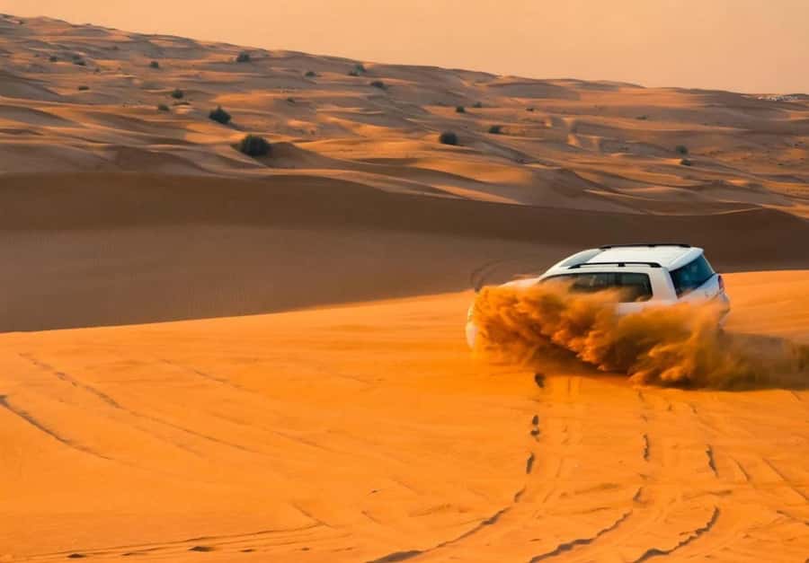 Dubai: Desert Safari, Camel Ride, Sandboard & Buffet Dinner - Dune bashing in a 4x4