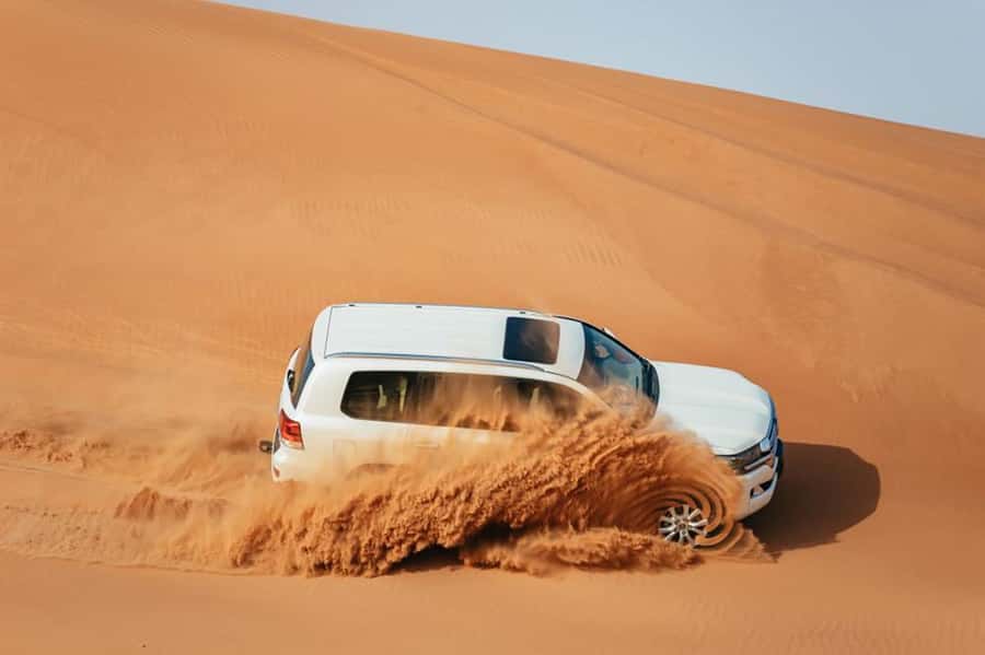 Dubai: Desert Safari, Camel Ride, Sandboarding, Quad Bike - Hotel pickup and the road to the desert