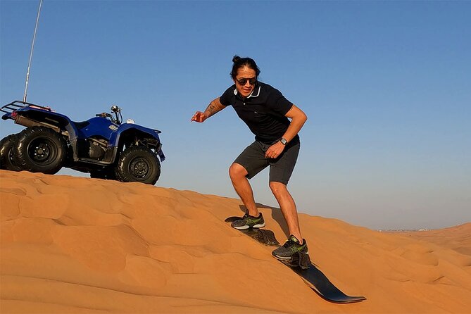 Dubai: Desert Safari, Camel Ride, Show & Optional Dinner - Sandboarding above the red dunes