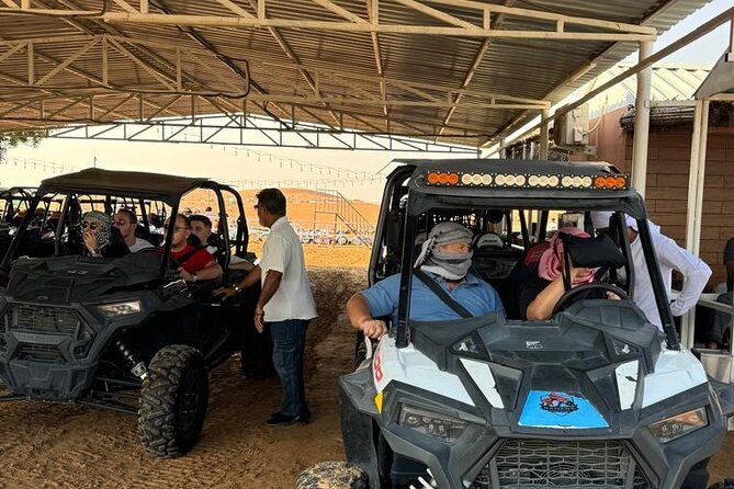 Dubai Desert Safari Dune Bashing, Camel Ride, Sandboarding & BBQ - Sunset at the Bedouin-inspired camp