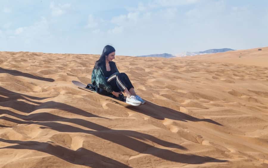 Dubai: Desert Safari, Quad Bike, Camel Ride and Sandboarding - Sandboarding and the sunset photo stop
