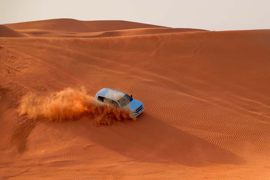Dubai: Desert Safari, Quad Bike, Sandboarding, Camels & BBQ - Sunset photos and a short camel ride