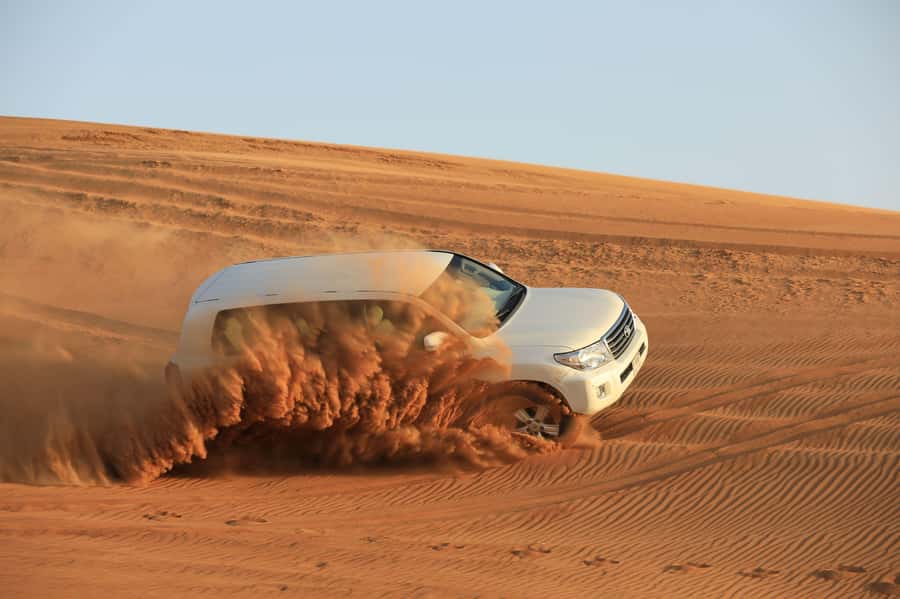 Dubai: Desert Safari, Quad Bike, Sandboarding, Camels & BBQ - BBQ dinner and evening entertainment