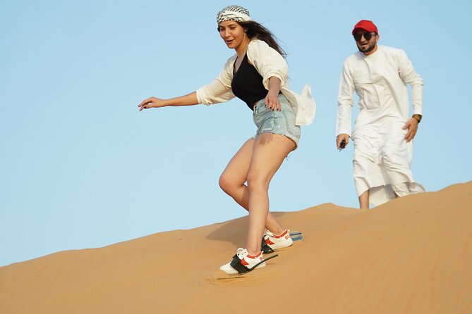 Dubai Desert Safari with 4x4 Cars, Live BBQ, Shows & Much more - Sandboarding on the Golden Slopes