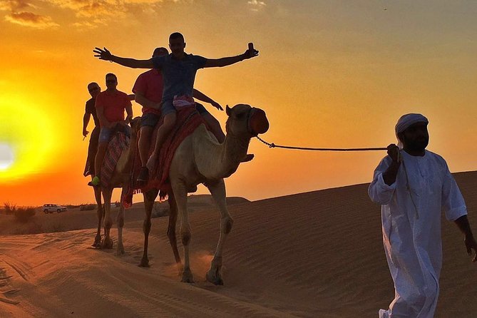 Dubai Desert Safari with BBQ And 4W Land Cruiser Dune Bashing Experience - Sunset, sandboarding, and the short camel ride