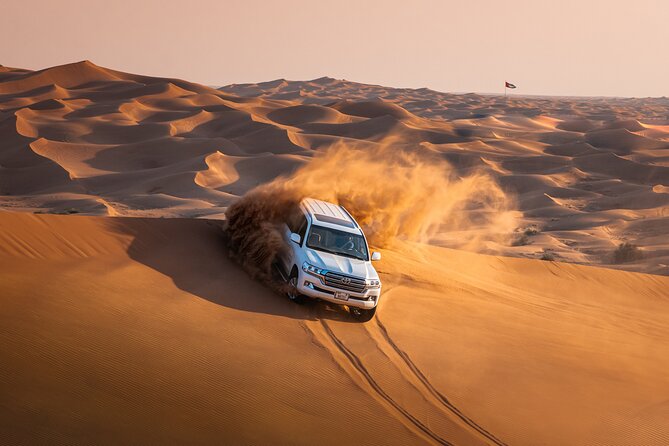 Dubai Desert Safari with Belly Dance, Fire Show and Tanura Show-The Full Package - Racing across Lahbab’s red dunes