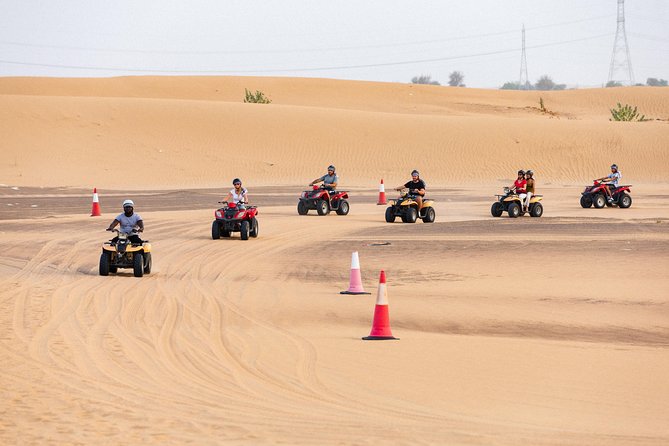 Dubai Desert Safari with Quads, BBQ Dinner, Camel ride, & Shows - Quad biking across the sand