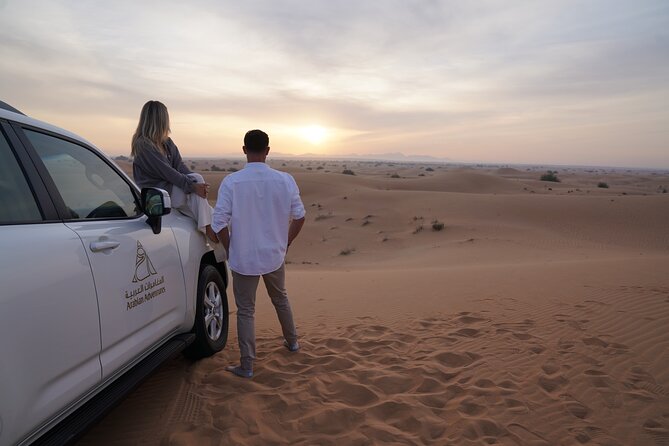 Dubai Evening Desert Safari: Sandboarding, BBQ, Camel Ride & more - Camel ride, sandboarding, and camp activities