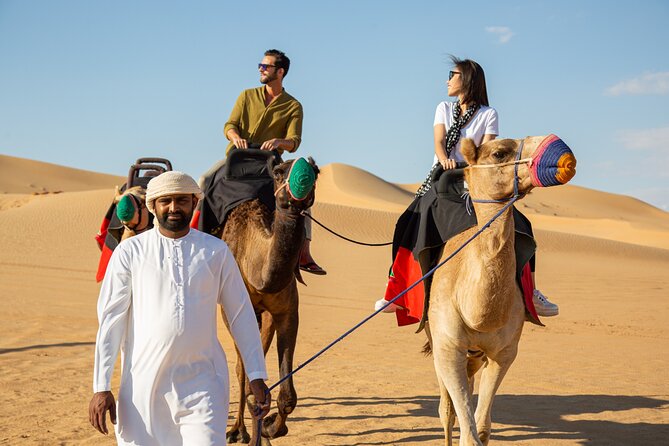 Dubai Evening Desert Safari: Sandboarding, BBQ, Camel Ride & more - Tanoura, belly dancing, and fire performance