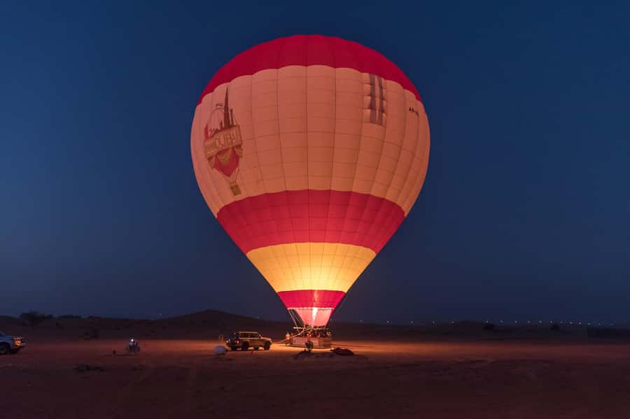 Dubai: Hot Air Balloon Ride with Camel Ride & Falcon Show - Floating above the red dunes