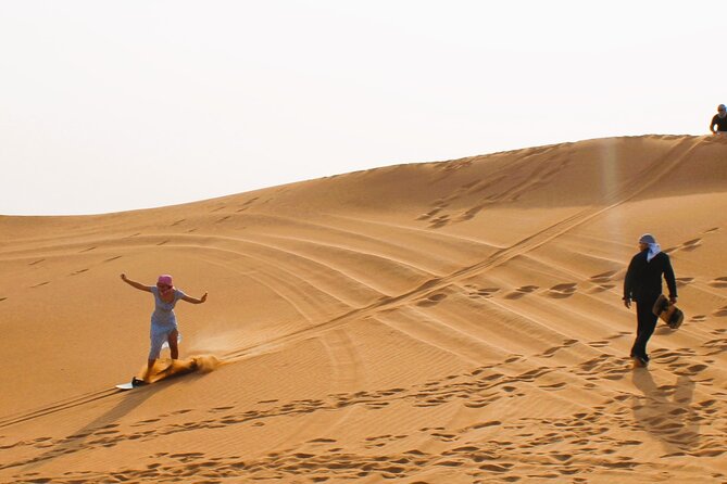 Dubai: Morning CaNam Buggy Safari with Sandboarding & Camel Ride - The guides and the human side