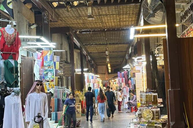 Dubai Old Town Walking Tour with Abra ride, Spice and Gold Souk - Shopping for cloth at the Textile Souk