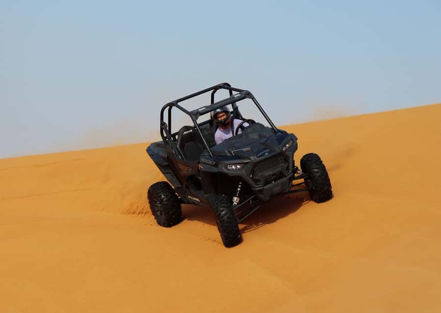 Dubai: Quad Bike, Dune Buggy, and Sandboarding Experience - Quad biking across the desert
