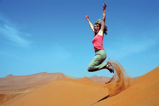 Dubai Red Dune Safari with BBQ Dinner and Live Shows - Sandboarding and the sunset photo stop