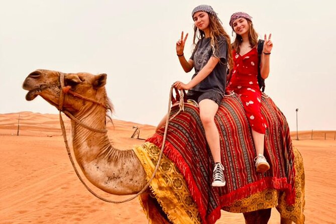 Dubai Red Dune Safari with Bedouin BBQ Dinner & Hotel Transfers - Sandboarding and sunset photos