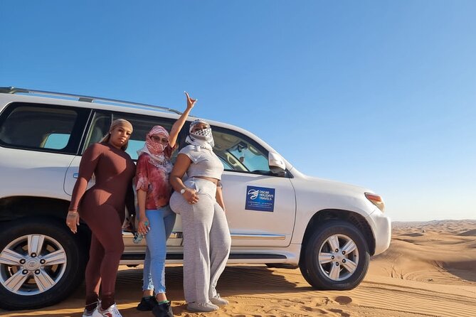 Dubai Red Dunes with Sandboarding, Camel Ride, Falcon & VIP Camp - Sunset over the Lahbab sand
