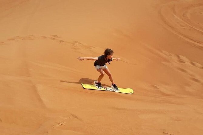 Dubai Self-drive Quad Bike, Sand Boarding, Camels & Refreshments - Sandboarding on the red dunes