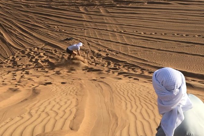 Dubai: Unique SUNSET Quad Bike Red Dunes Safari - Sandboarding adds a short burst of fun