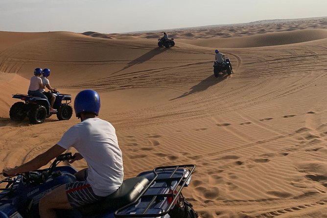 Dubai: Unique SUNSET Quad Bike Red Dunes Safari - A camel ride gives the evening a slower rhythm