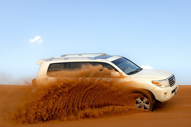 Evening Desert Safari in Dubai, Sandboard & BBQ Dinner - Sandboarding on the high red dunes