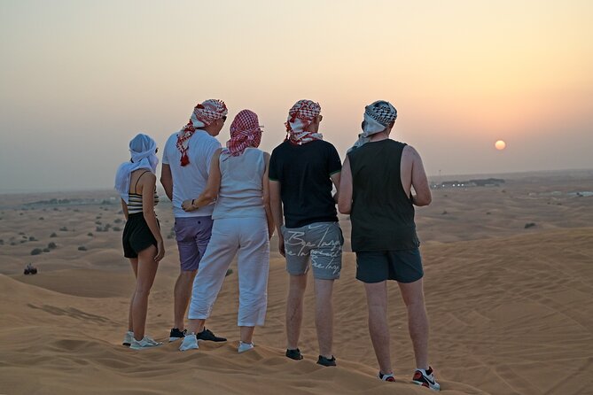 Evening Desert Safari in Dubai, Sandboard & BBQ Dinner - Camel ride, henna, falconry, and camp traditions