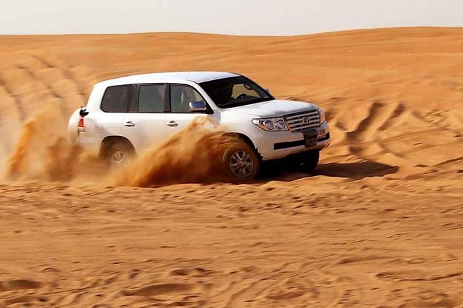 Evening Desert Safari with, Dune Bashing, Camel Ride, sand board - Sandboarding on the dunes
