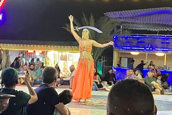 Guided Desert Safari with Dinner and Quad Biking in Dubai - Tanura, fire, and belly-dance performances