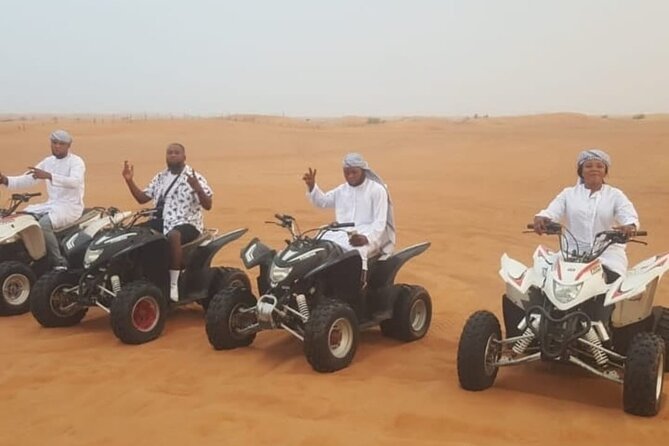 Quad Bike Dubai Desert Safari with BBQ Dinner Sandboard and Show - From Dubai pickup to the red dunes of Lahbab