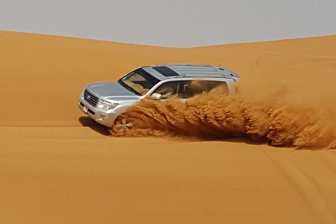 Red Dunes Desert Safari with BBQ Dinner - Sandboarding and the sunset photo stop